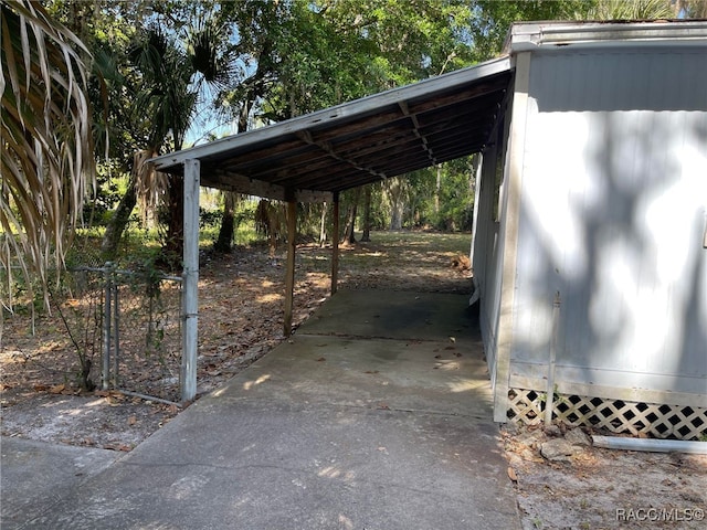 120 NW Magnolia Cir, Crystal River, FL 34428 - view of car parking with a carport and concrete driveway