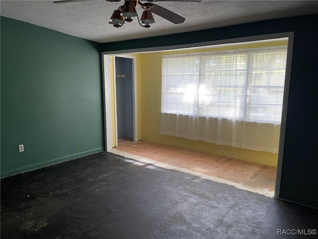 120 NW Magnolia Cir, Crystal River, FL 34428 - empty room with a ceiling fan, a textured ceiling, and concrete floors