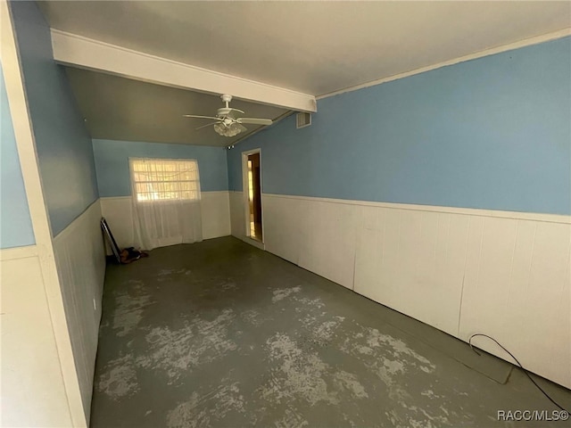 120 NW Magnolia Cir, Crystal River, FL 34428 - empty room featuring unfinished concrete flooring, wainscoting, and a ceiling fan