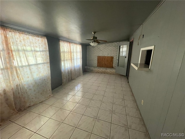 120 NW Magnolia Cir, Crystal River, FL 34428 - unfurnished room featuring ceiling fan, light tile patterned flooring, plenty of natural light, a brick fireplace, and brick wall