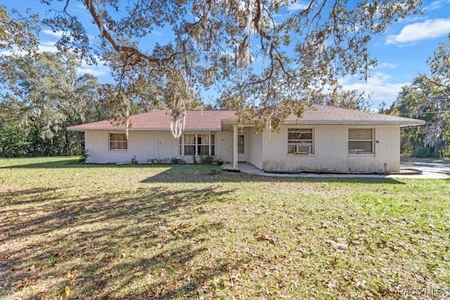 single story home featuring cooling unit and a front yard