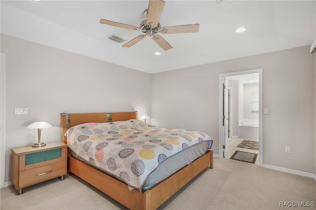 carpeted bedroom with connected bathroom and ceiling fan