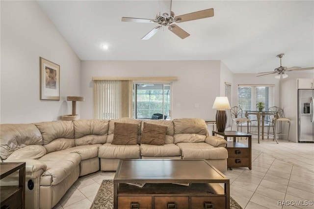 living room with light tile patterned flooring, ceiling fan, and lofted ceiling