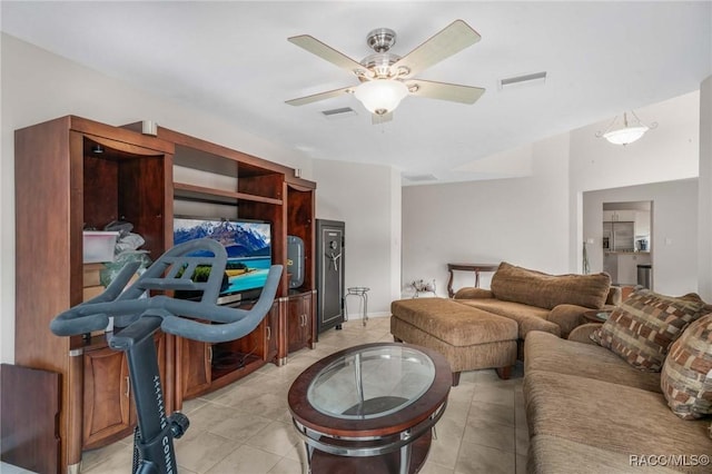 tiled living room with ceiling fan