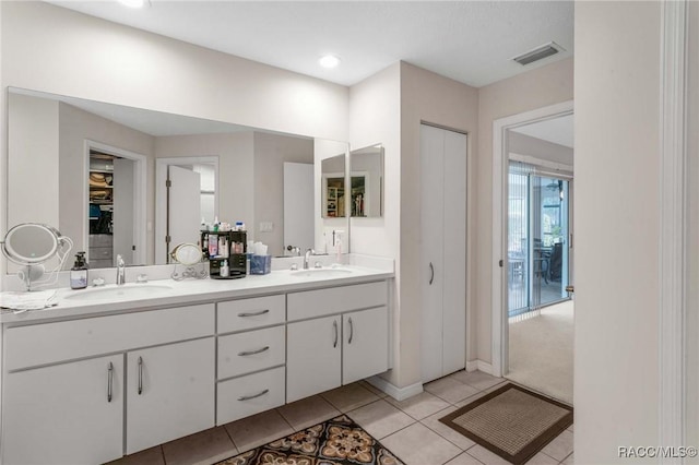 bathroom featuring tile patterned flooring and vanity