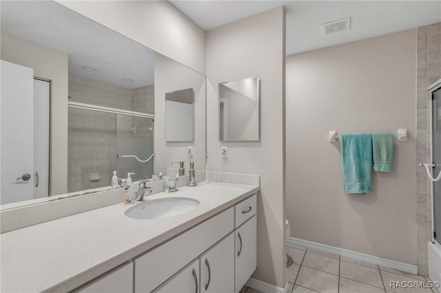 bathroom featuring tile patterned flooring, vanity, and toilet