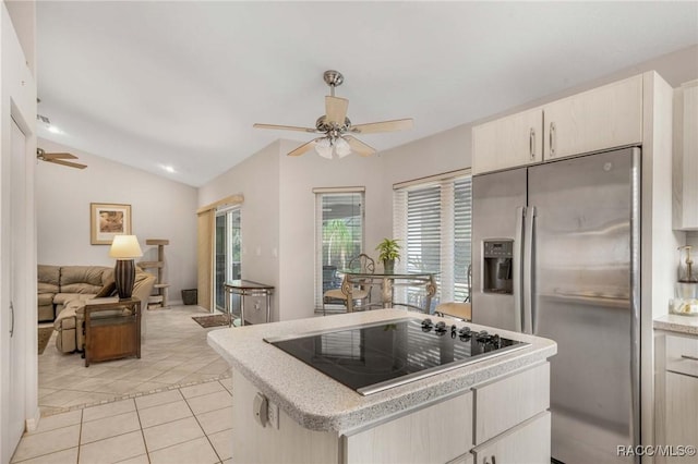 kitchen with vaulted ceiling, light tile patterned flooring, stainless steel fridge, ceiling fan, and black electric cooktop