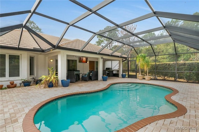 view of swimming pool with area for grilling, a lanai, and a patio area