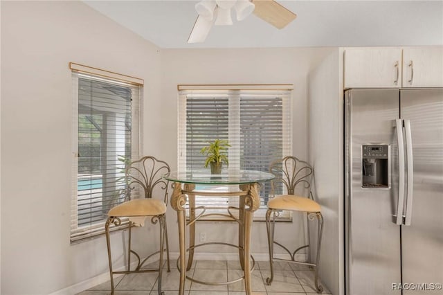 tiled dining area with ceiling fan