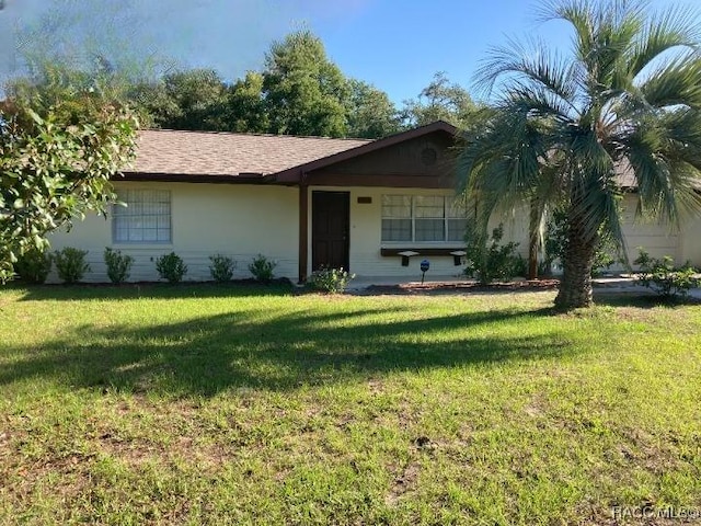 ranch-style home featuring a front lawn