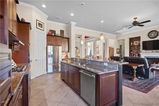 kitchen featuring sink, hanging light fixtures, stainless steel appliances, a kitchen island with sink, and light tile patterned flooring