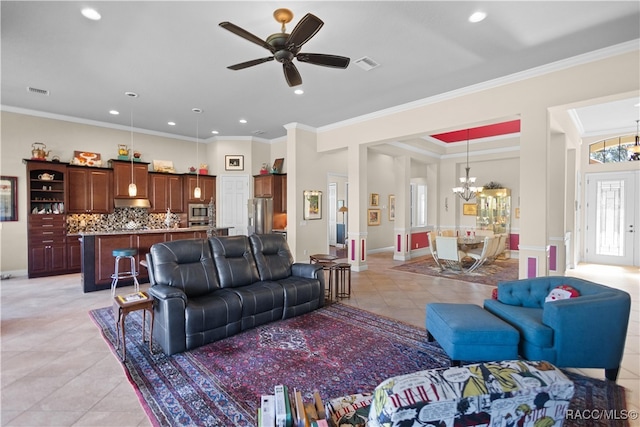 living room with light tile patterned floors, ceiling fan with notable chandelier, and ornamental molding