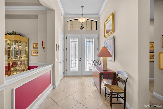 tiled foyer entrance with crown molding and french doors