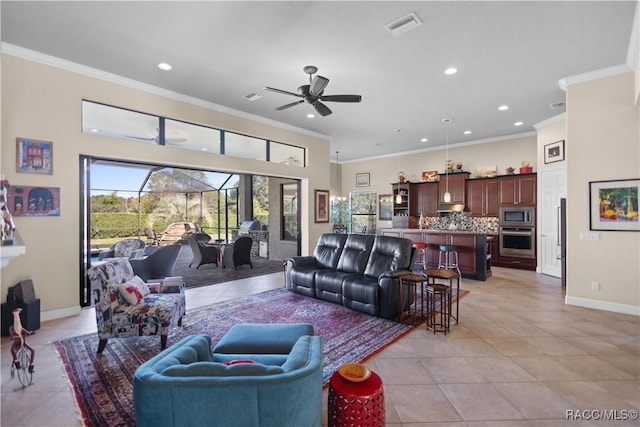 living room with light tile patterned floors, ceiling fan, and crown molding