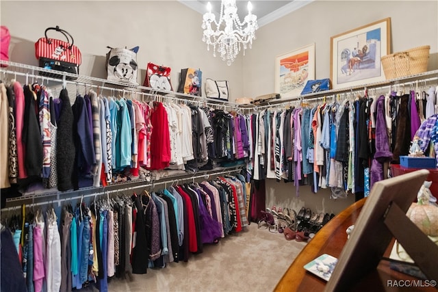 spacious closet with carpet floors and an inviting chandelier