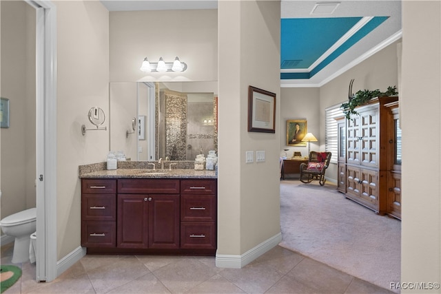 bathroom with tile patterned flooring, a shower, toilet, vanity, and ornamental molding