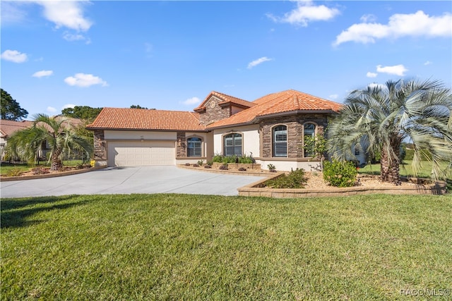 mediterranean / spanish house featuring a garage and a front lawn