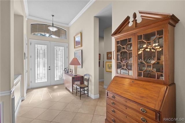 tiled foyer featuring french doors and ornamental molding