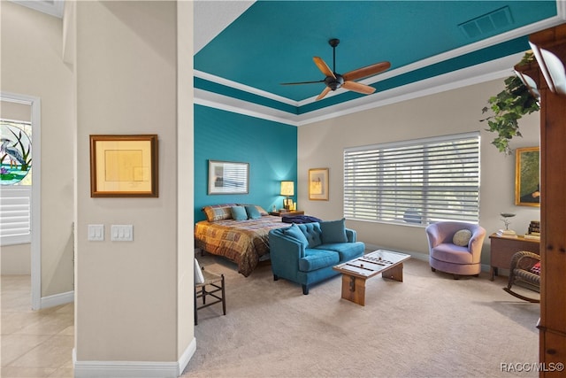 bedroom featuring ceiling fan, crown molding, and a tray ceiling