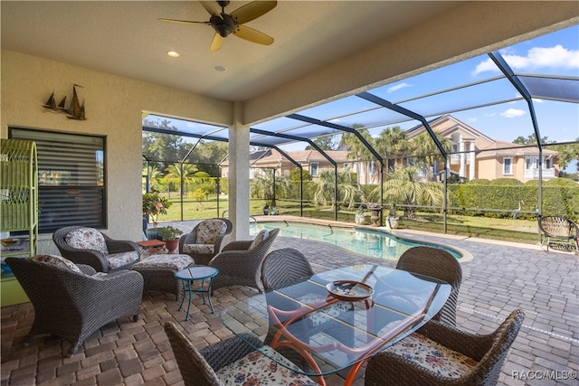 view of patio featuring glass enclosure and ceiling fan