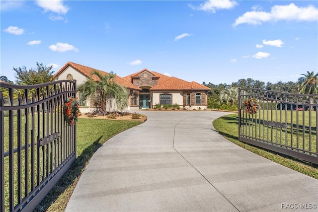 mediterranean / spanish home with a front lawn