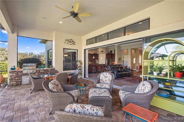 view of patio with a grill, ceiling fan, exterior kitchen, and an outdoor hangout area