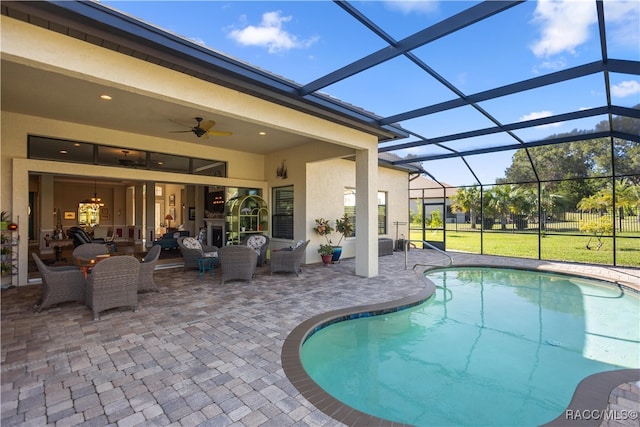 view of pool featuring glass enclosure, ceiling fan, and a patio area