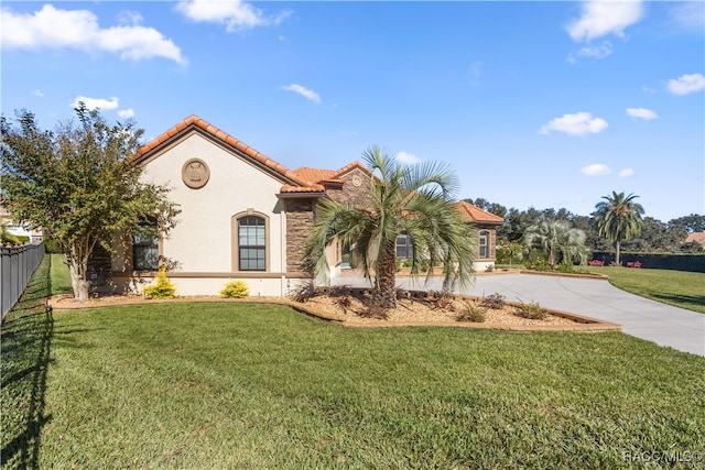 mediterranean / spanish-style house with a front lawn