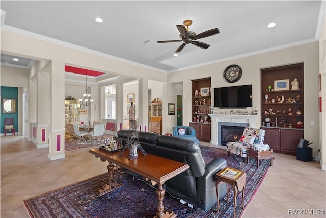 tiled living room featuring ornamental molding, ceiling fan with notable chandelier, and built in features