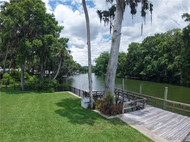 5217 Riverside Dr, Yankeetown, FL 34498 - view of green lawn featuring a water view and a boat dock