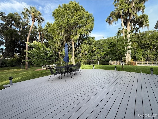 5217 Riverside Dr, Yankeetown, FL 34498 - wooden terrace with outdoor dining space and view of scattered trees