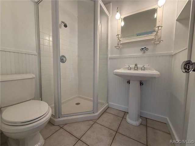 5217 Riverside Dr, Yankeetown, FL 34498 - bathroom featuring a stall shower, wainscoting, and tile patterned floors