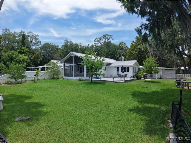 5217 Riverside Dr, Yankeetown, FL 34498 - fenced backyard with a sunroom, a patio area, and an outdoor structure