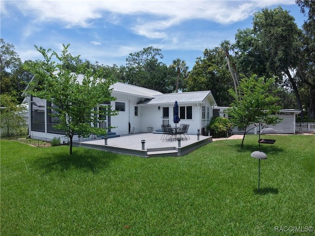 5217 Riverside Dr, Yankeetown, FL 34498 - rear view of property with a deck, a yard, and a metal roof