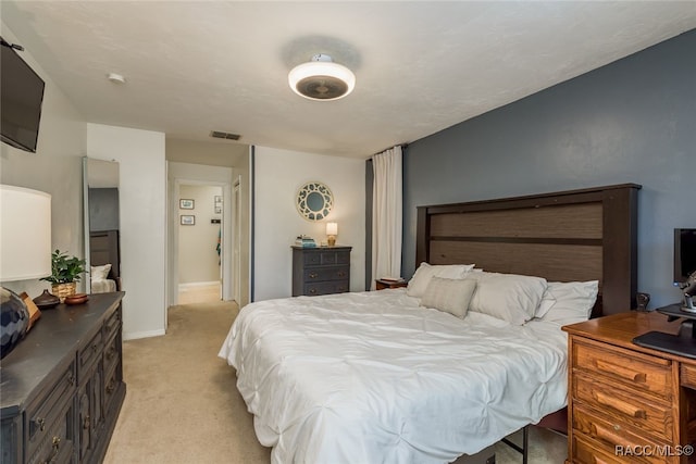 bedroom with light colored carpet