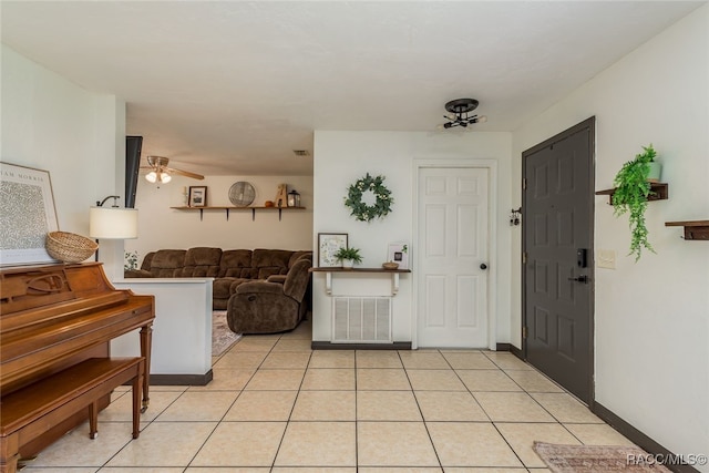 entryway featuring ceiling fan and light tile patterned flooring