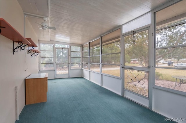 unfurnished sunroom featuring ceiling fan