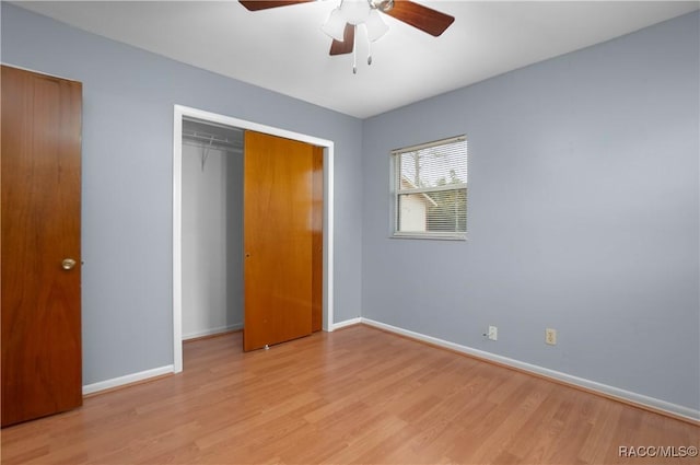 unfurnished bedroom with light hardwood / wood-style flooring, a closet, and ceiling fan