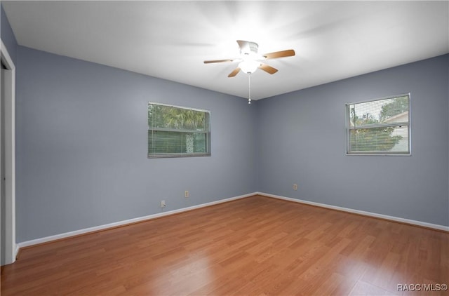 spare room with ceiling fan and light hardwood / wood-style flooring