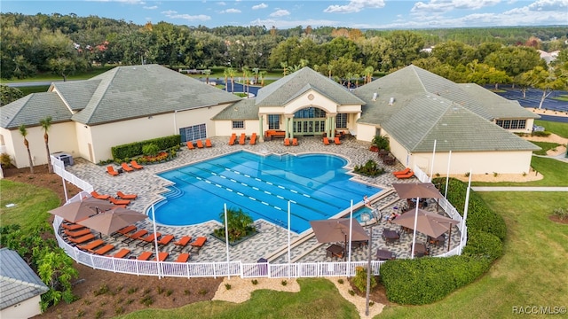 view of swimming pool featuring a yard and a patio