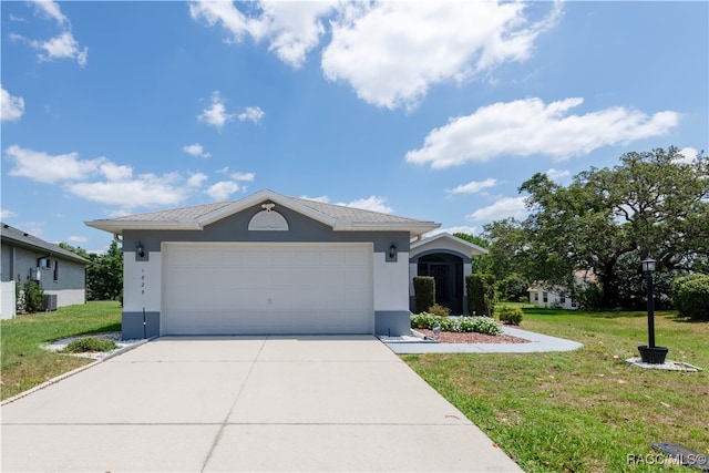 view of front of property with a front yard and a garage