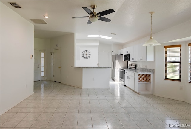 kitchen featuring white cabinetry, ceiling fan, stainless steel appliances, and light tile patterned floors