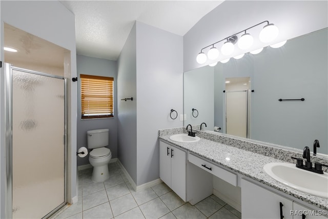 bathroom featuring tile patterned floors, a textured ceiling, toilet, a shower with door, and vanity