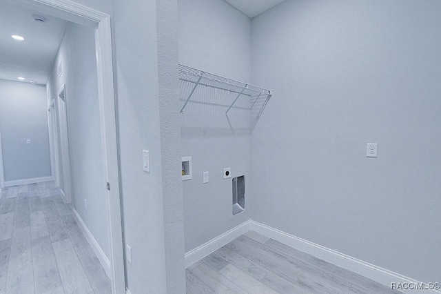 clothes washing area featuring hookup for an electric dryer, light hardwood / wood-style floors, and hookup for a washing machine