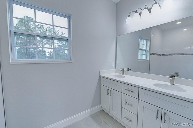 bathroom with tile patterned flooring, vanity, and a wealth of natural light