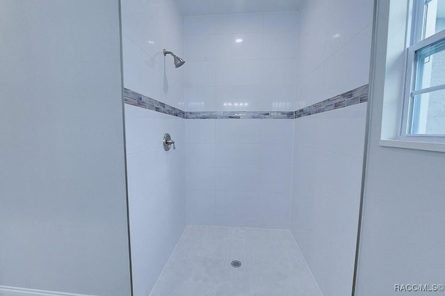 bathroom with a tile shower