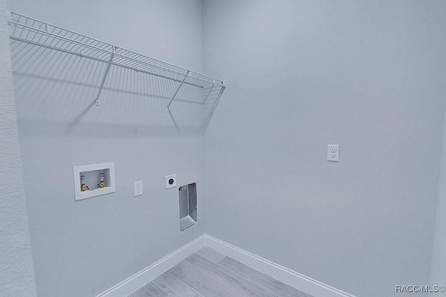 clothes washing area featuring washer hookup, hardwood / wood-style flooring, and electric dryer hookup