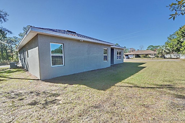 view of home's exterior featuring cooling unit and a yard