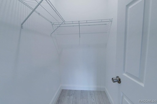 walk in closet featuring light hardwood / wood-style flooring