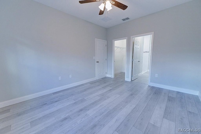 spare room with light hardwood / wood-style floors and ceiling fan